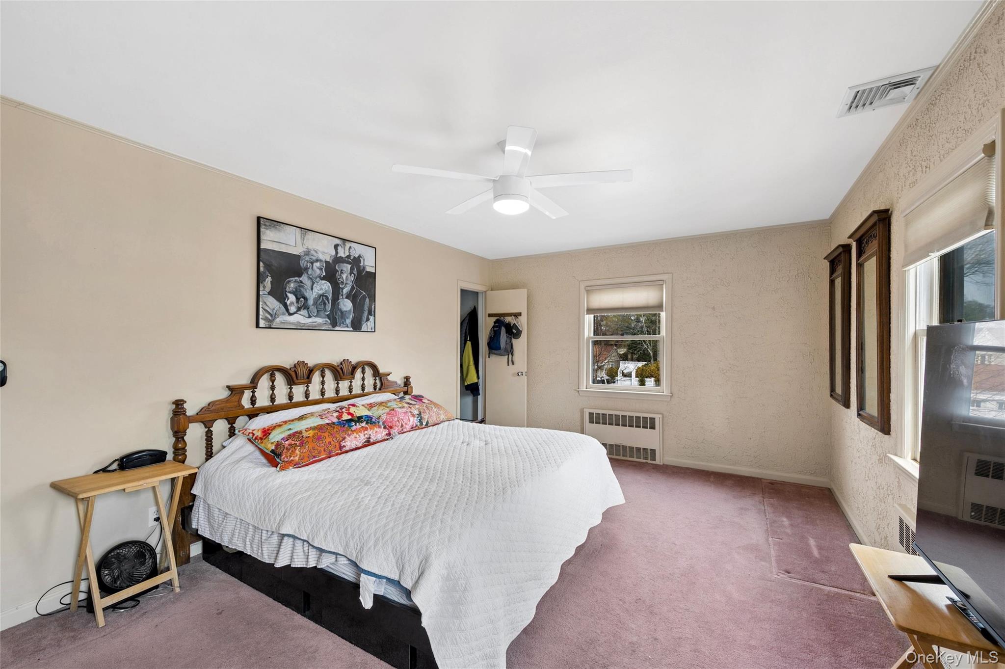 24 Allen Road Rockville Centre, NY 11570 - Photo 23 of 46 a bedroom with a large bed and a chandelier