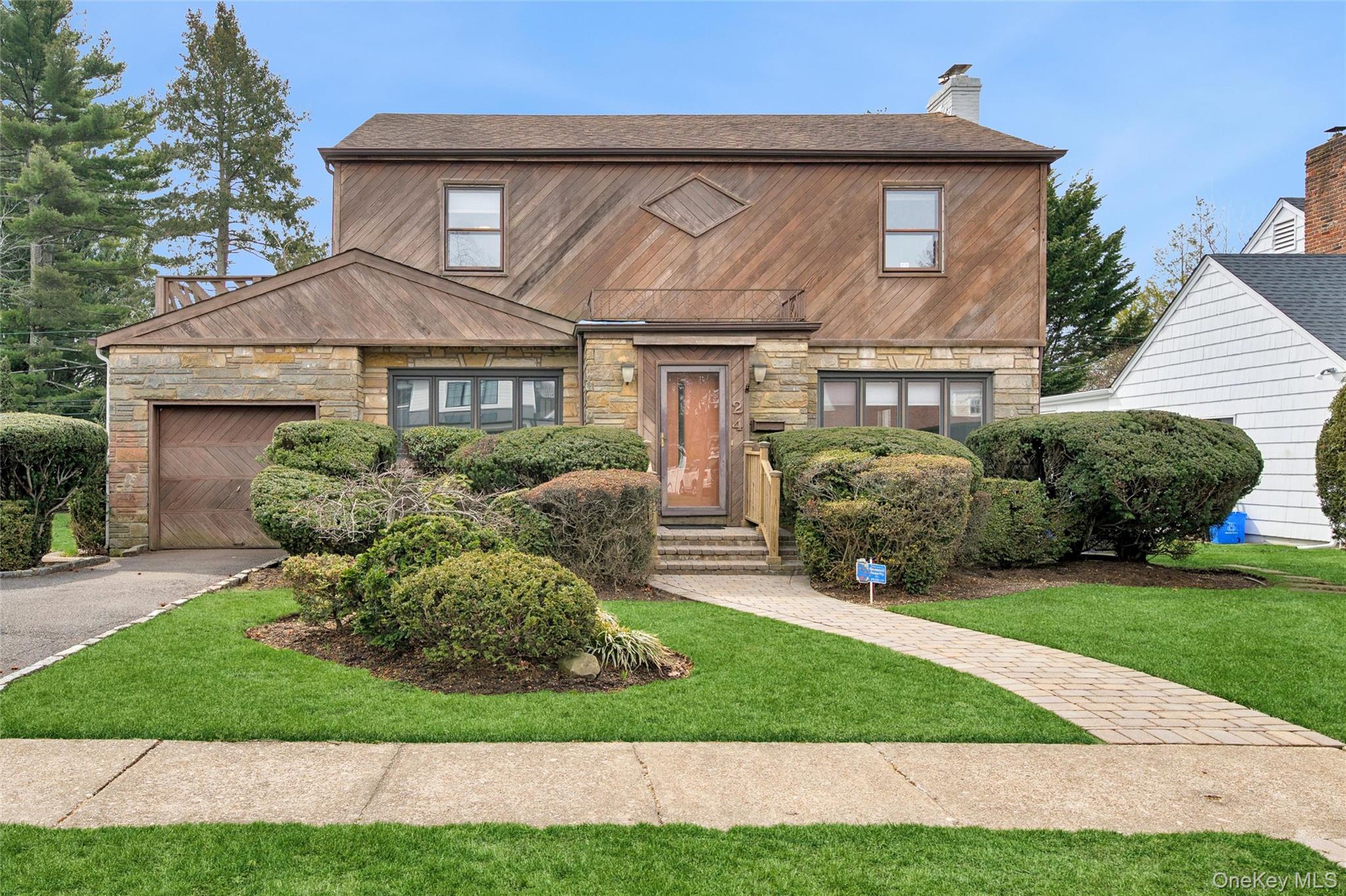 24 Allen Road Rockville Centre, NY 11570 - Photo 3 of 46 a front view of a house with a yard