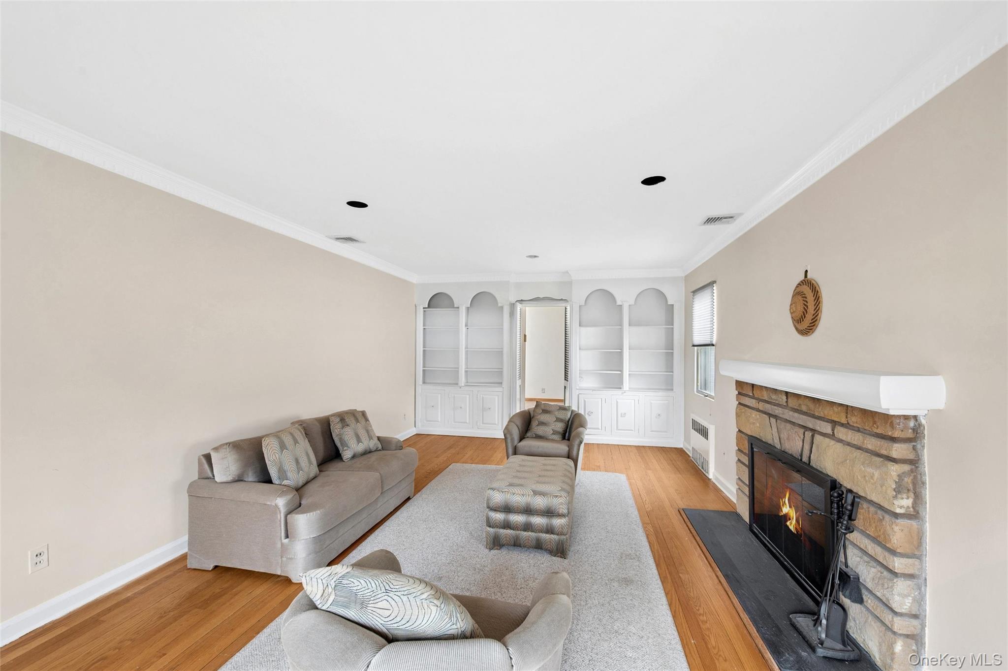 24 Allen Road Rockville Centre, NY 11570 - Photo 5 of 46 a living room with furniture and a fireplace