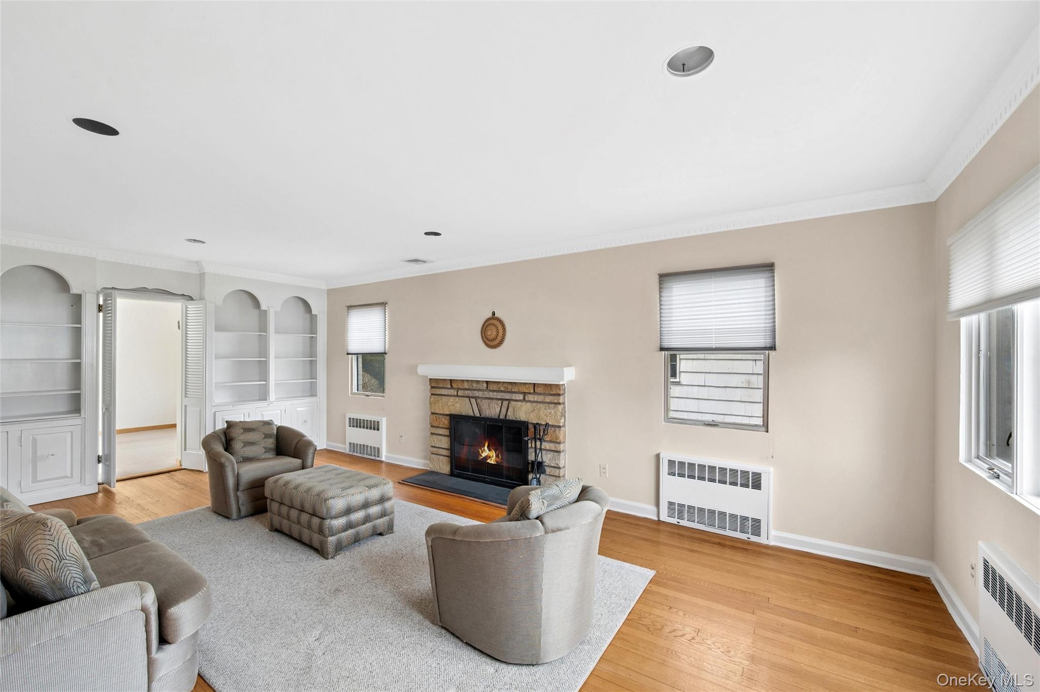 24 Allen Road Rockville Centre, NY 11570 - Photo 6 of 46 a living room with furniture a fireplace and a window