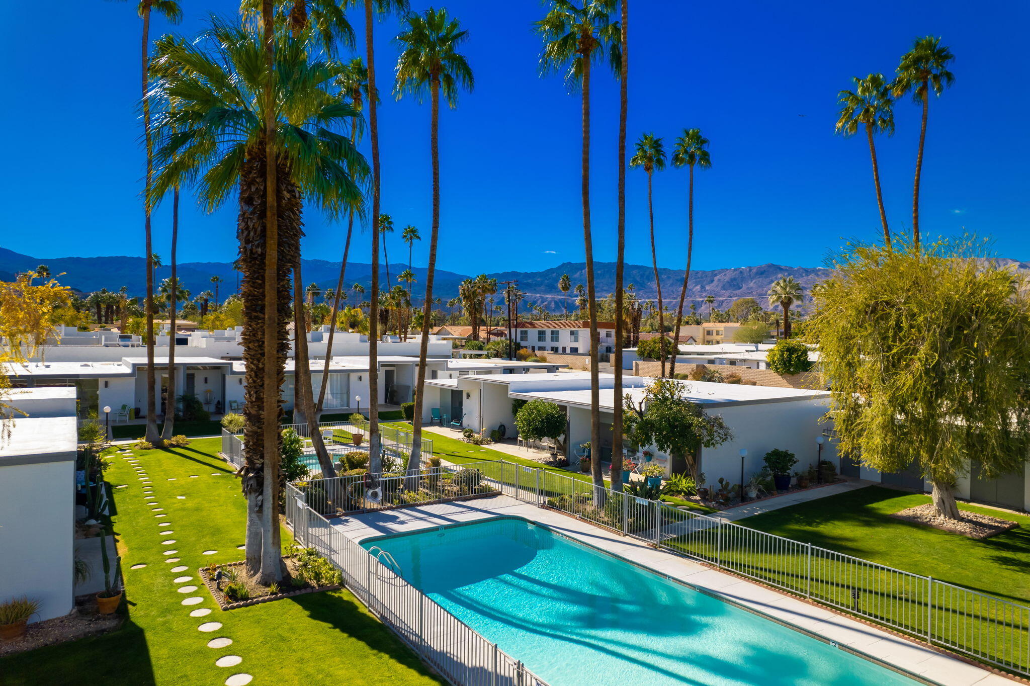 45301 Deep Canyon Road, Unit 21 Palm Desert, CA 92260 - Photo 1 of 46 a view of a house with a swimming pool