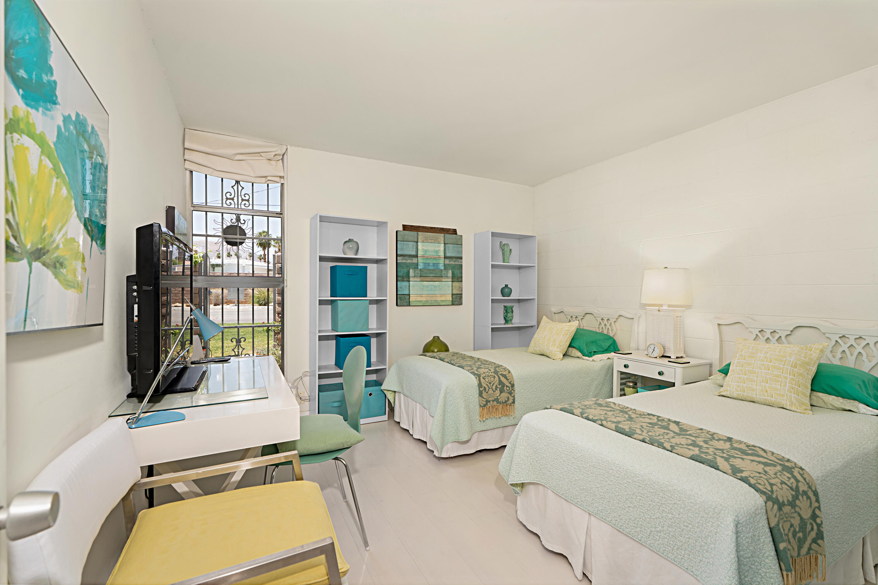 45301 Deep Canyon Road, Unit 21 Palm Desert, CA 92260 - Photo 16 of 46 a bedroom with two beds and a large window