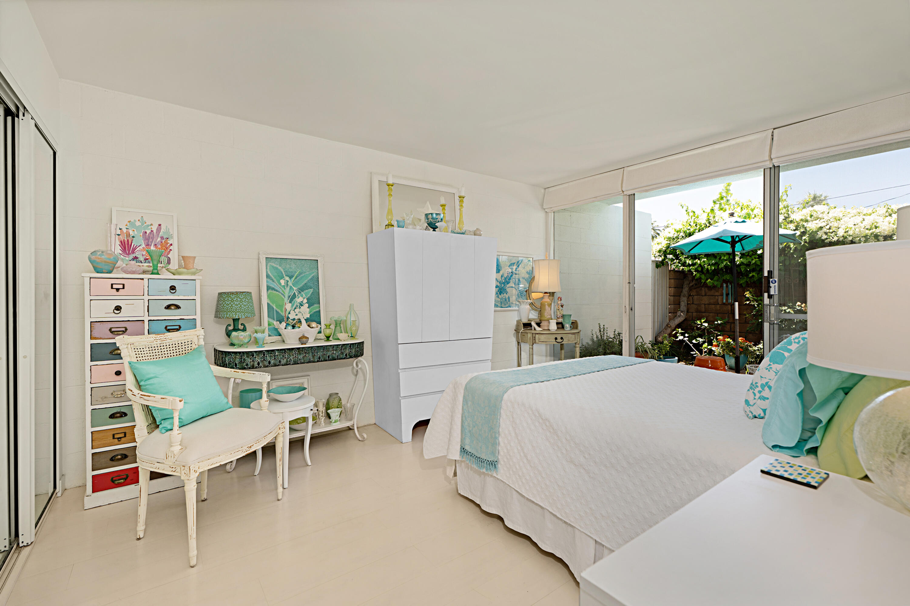 45301 Deep Canyon Road, Unit 21 Palm Desert, CA 92260 - Photo 18 of 46 a bedroom with a bed table chair and a window