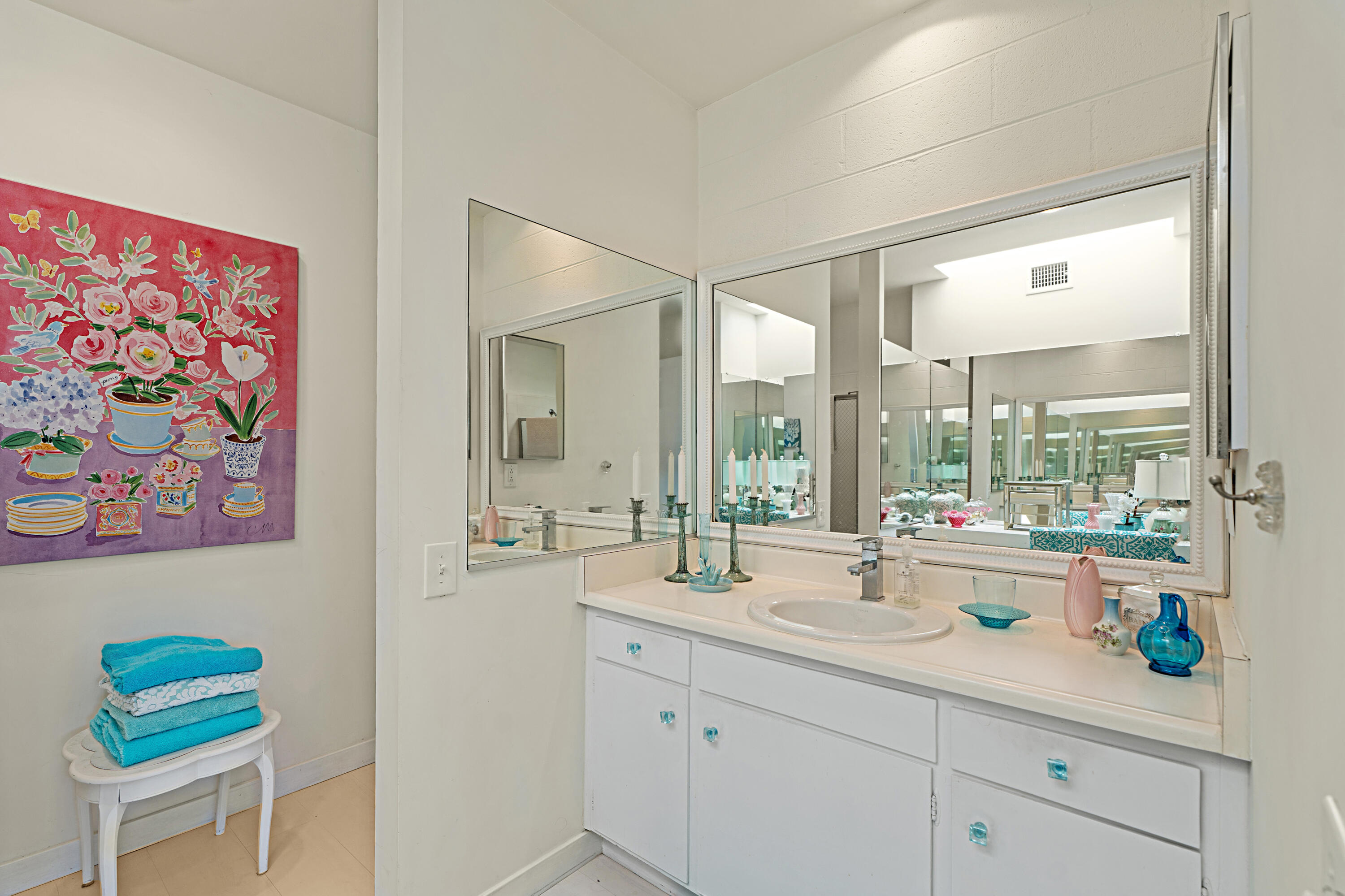 45301 Deep Canyon Road, Unit 21 Palm Desert, CA 92260 - Photo 21 of 46 a bathroom with a double vanity sink and a large mirror