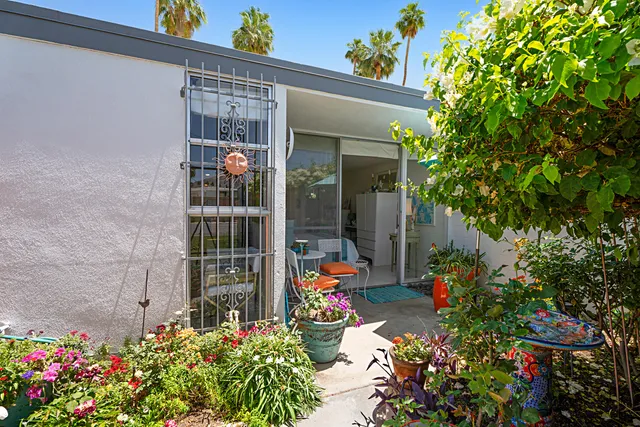 a view of a house with potted plants