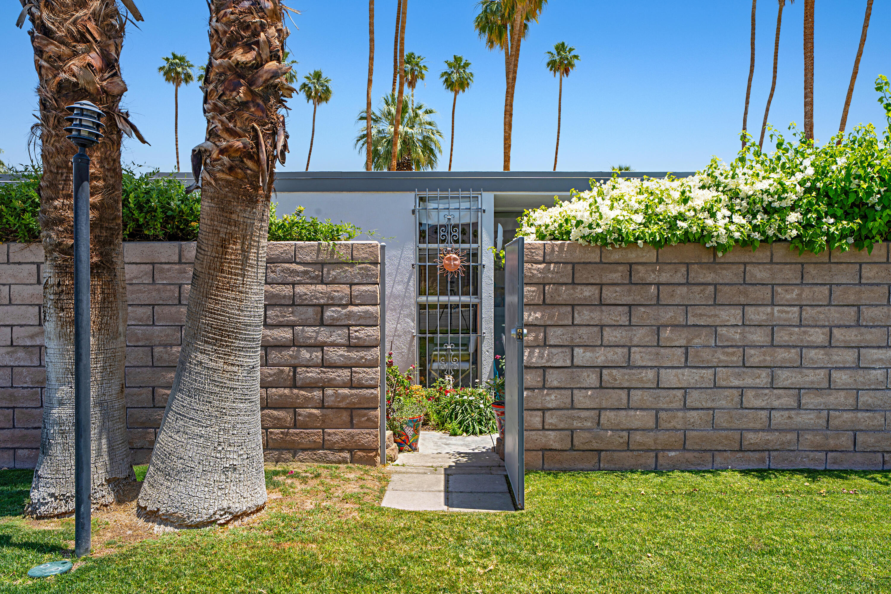 45301 Deep Canyon Road, Unit 21 Palm Desert, CA 92260 - Photo 28 of 46 a view of a house with potted plants