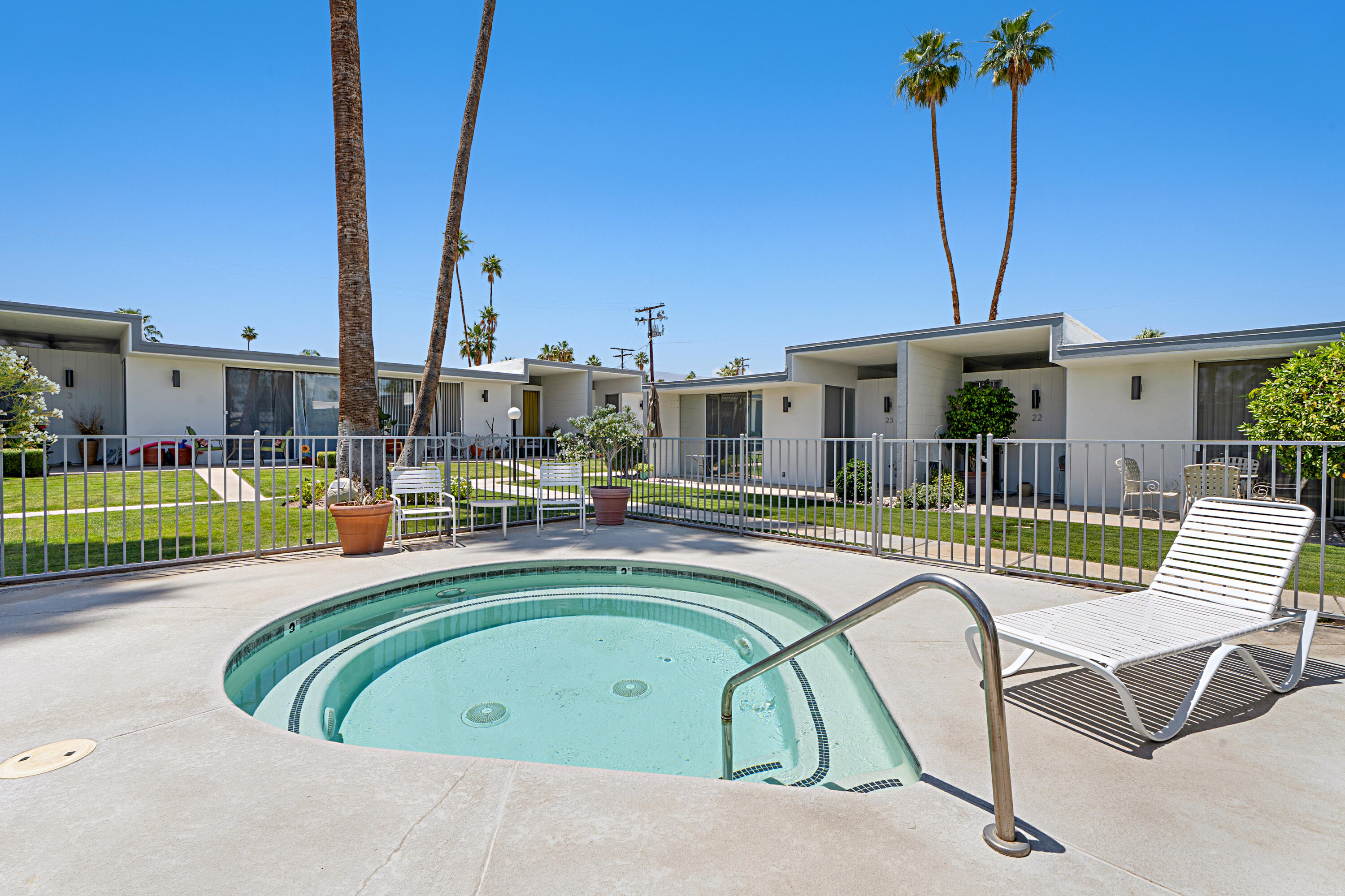45301 Deep Canyon Road, Unit 21 Palm Desert, CA 92260 - Photo 45 of 46 a view of a swimming pool with a lounge chairs