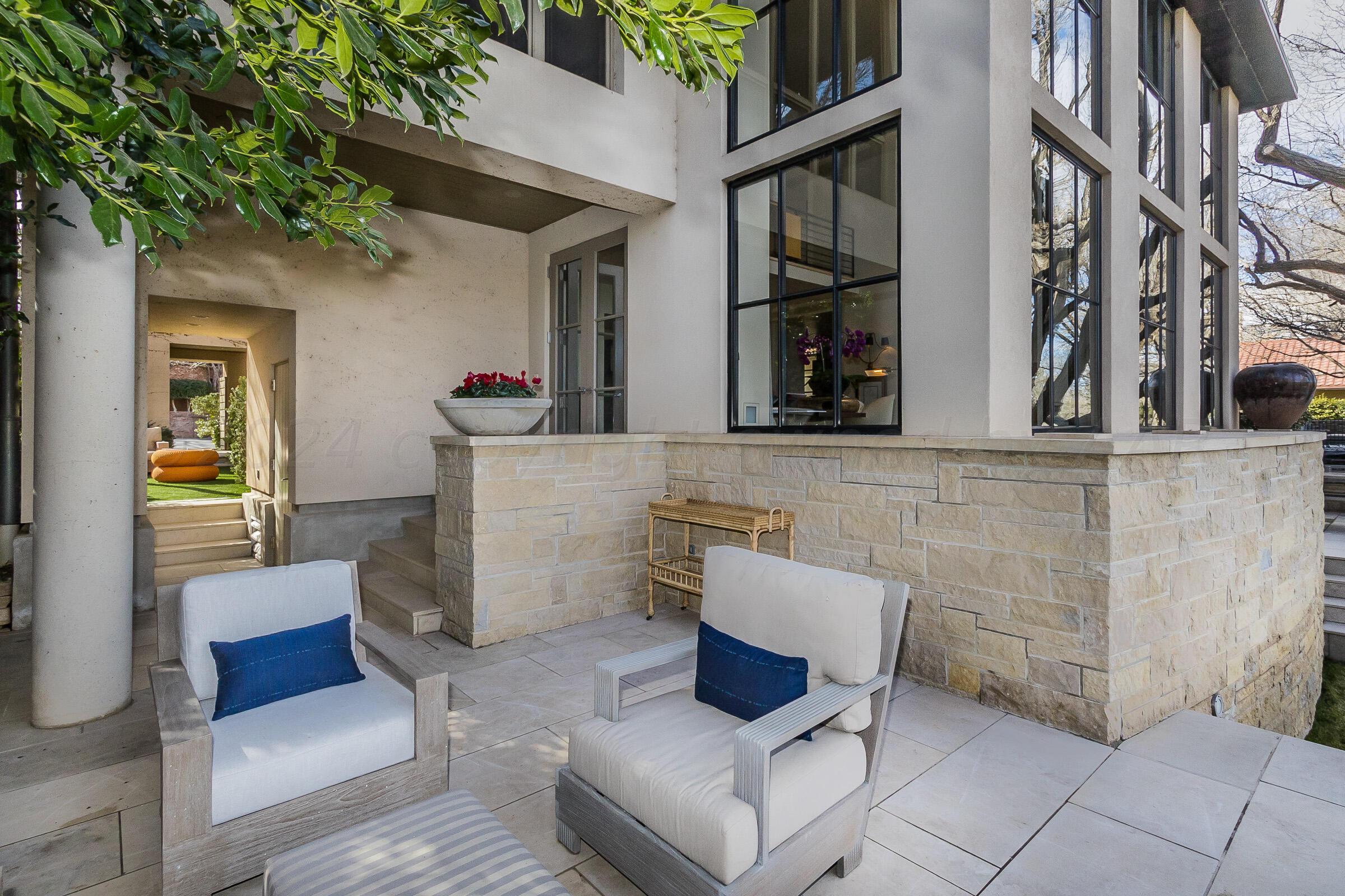 2 Edgewater Drive Amarillo, TX 79106 - Photo 43 of 51 a view of a patio with couches and a potted plant on a brick wall