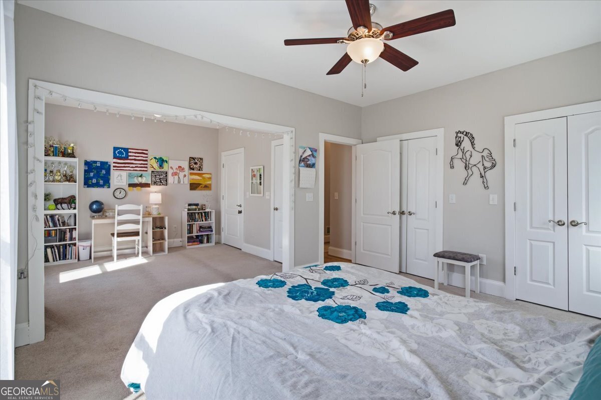 204 Staples Dairy Road Carrollton, GA 30116 - Photo 28 of 85 a bedroom with a large bed and a chandelier
