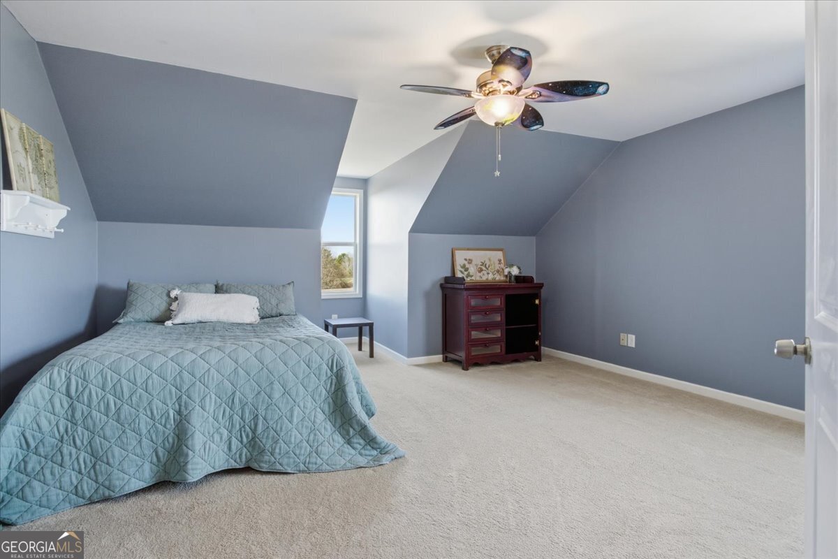 204 Staples Dairy Road Carrollton, GA 30116 - Photo 40 of 85 a spacious bedroom with a bed and a chandelier