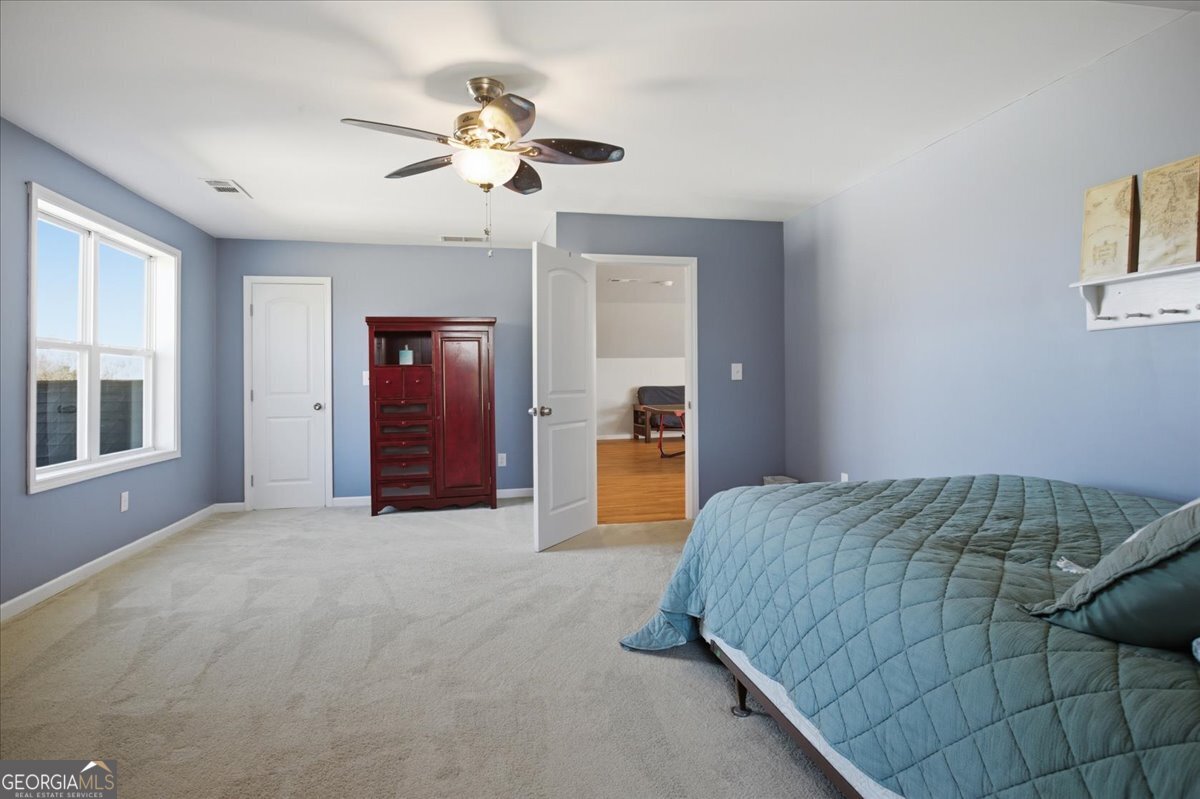 204 Staples Dairy Road Carrollton, GA 30116 - Photo 41 of 85 a spacious bedroom with a bed and a chandelier