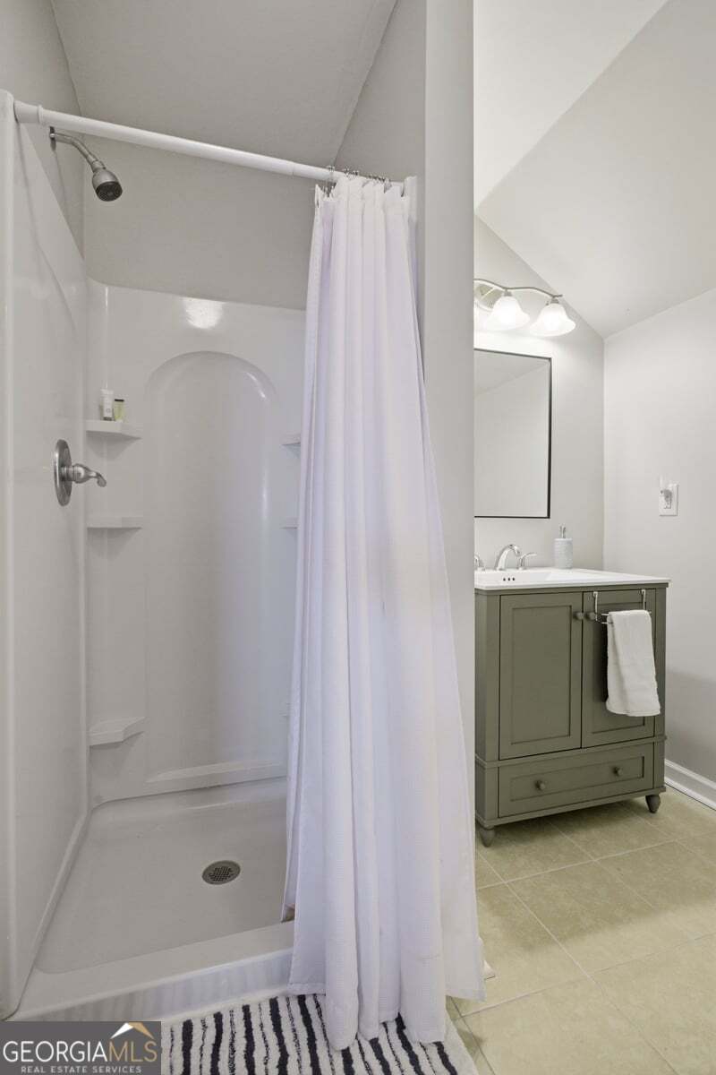 204 Staples Dairy Road Carrollton, GA 30116 - Photo 42 of 85 a bathroom with a sink a mirror and a shower