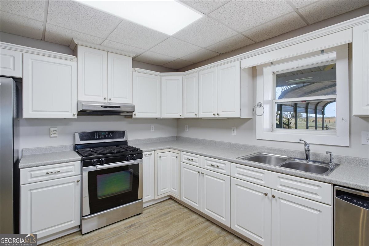 204 Staples Dairy Road Carrollton, GA 30116 - Photo 47 of 85 a kitchen with cabinets appliances a sink and a counter top