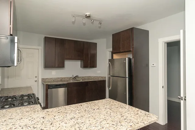 a kitchen with a refrigerator and a sink