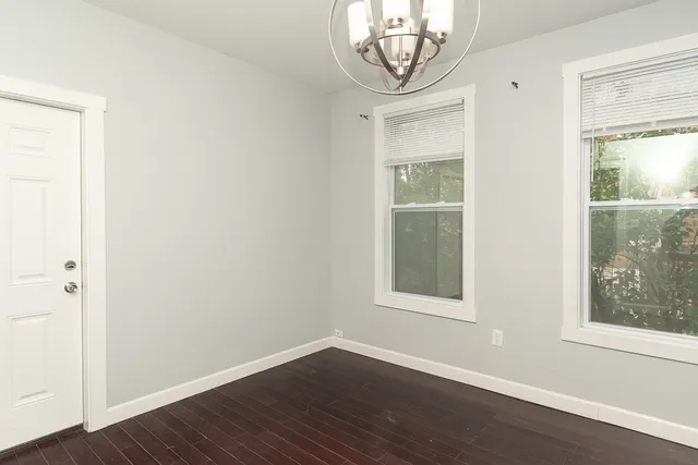 an empty room with wooden floor