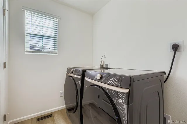 a view of a storage and utility room with washer and dryer