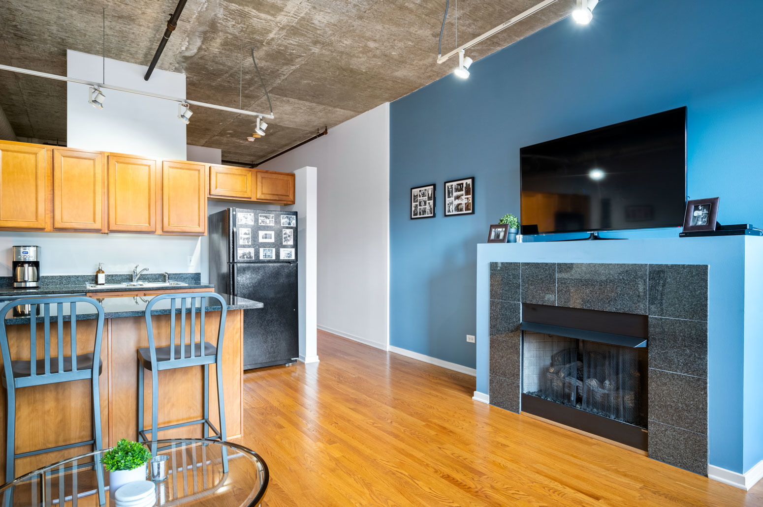 849 North Franklin Street, Unit 715 Chicago, IL 60610 - Photo 11 of 26 a living room with furniture a flat screen tv and a fireplace