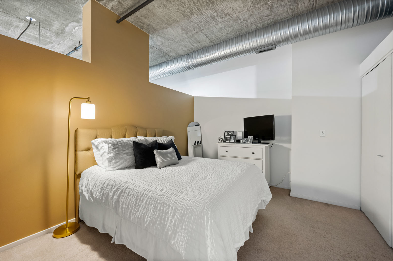 849 North Franklin Street, Unit 715 Chicago, IL 60610 - Photo 12 of 26 a bedroom with a bed and a flat screen tv