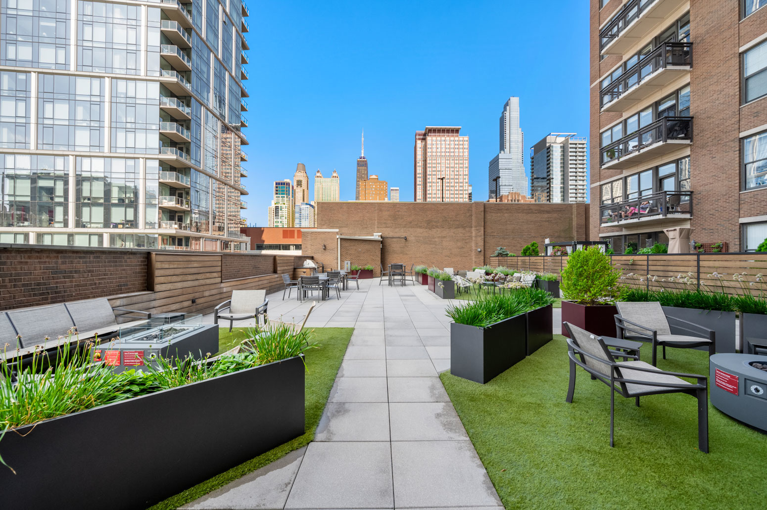 849 North Franklin Street, Unit 715 Chicago, IL 60610 - Photo 21 of 26 a view of a patio with couches and table potted plants