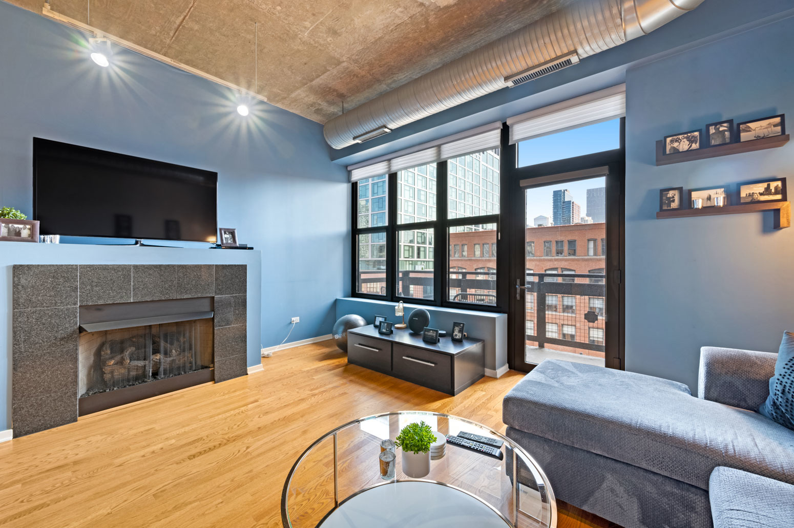849 North Franklin Street, Unit 715 Chicago, IL 60610 - Photo 5 of 26 a living room with furniture a flat screen tv and a fireplace