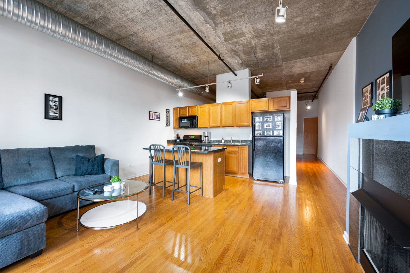 849 North Franklin Street, Unit 715 Chicago, IL 60610 - Photo 8 of 26 a living room with furniture and a flat screen tv