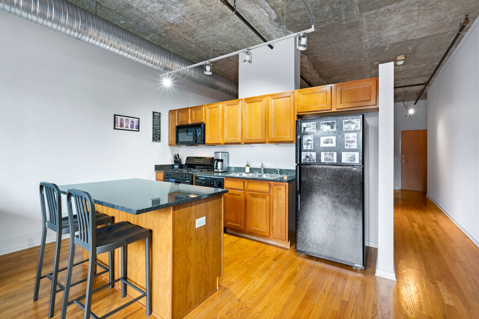 849 North Franklin Street, Unit 715 Chicago, IL 60610 - Photo 9 of 26 a kitchen that has a table and chairs in it