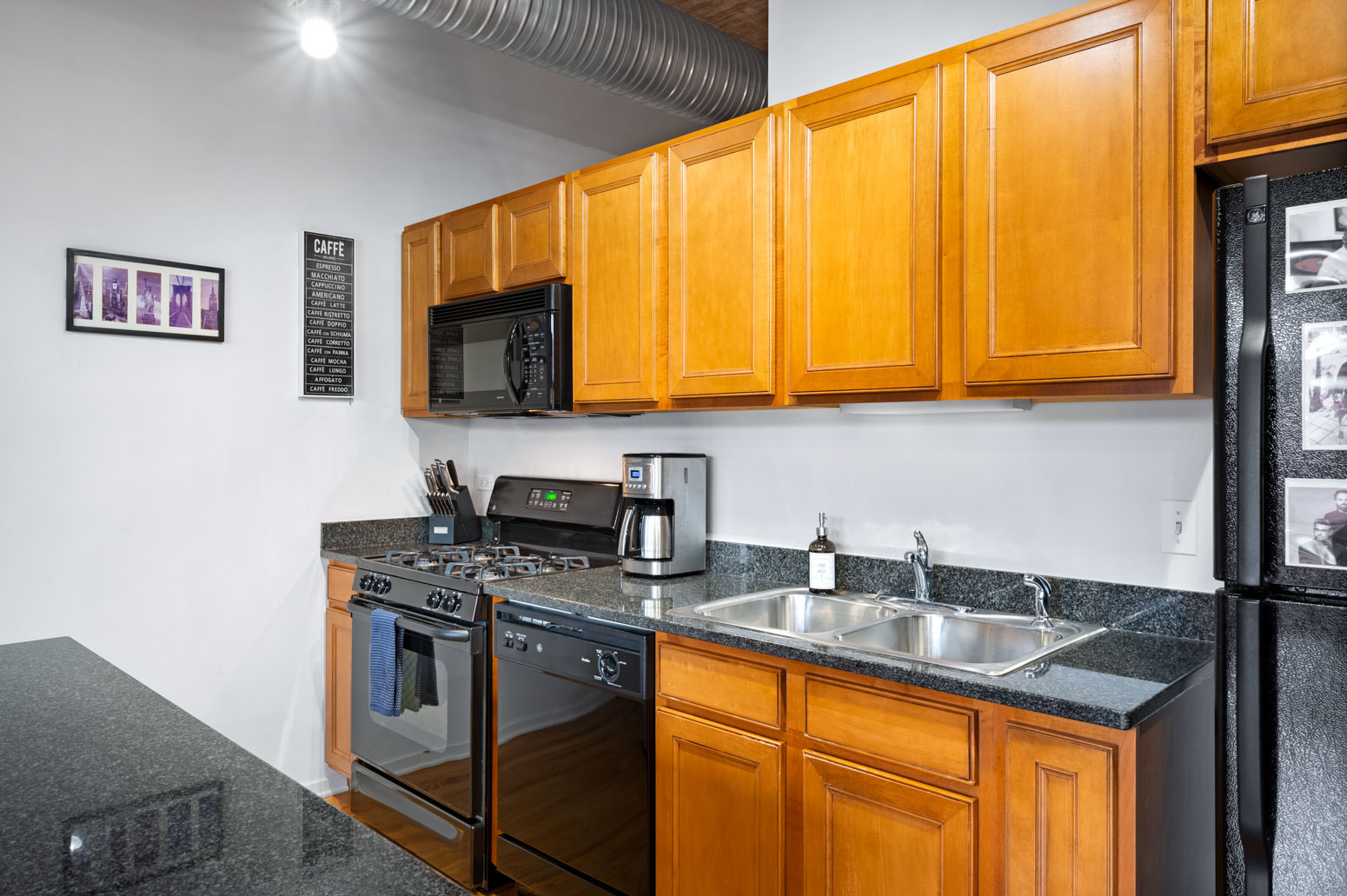849 North Franklin Street, Unit 715 Chicago, IL 60610 - Photo 10 of 26 a kitchen with stainless steel appliances granite countertop a stove a sink and a microwave