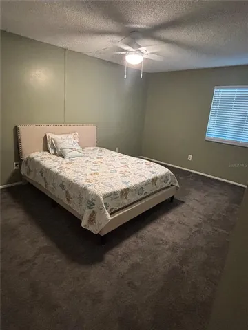 a bedroom with a bed and lamp