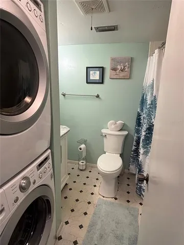 a bathroom with a toilet and a washing machine