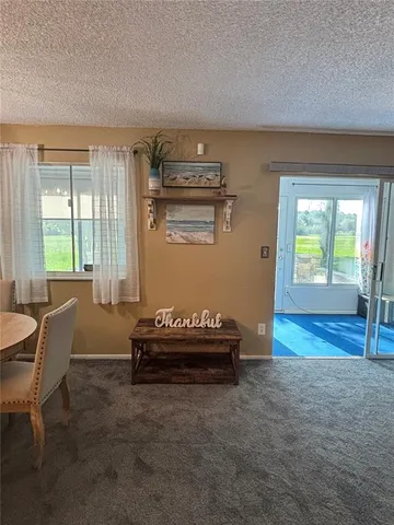 a living room with furniture and a floor to ceiling window