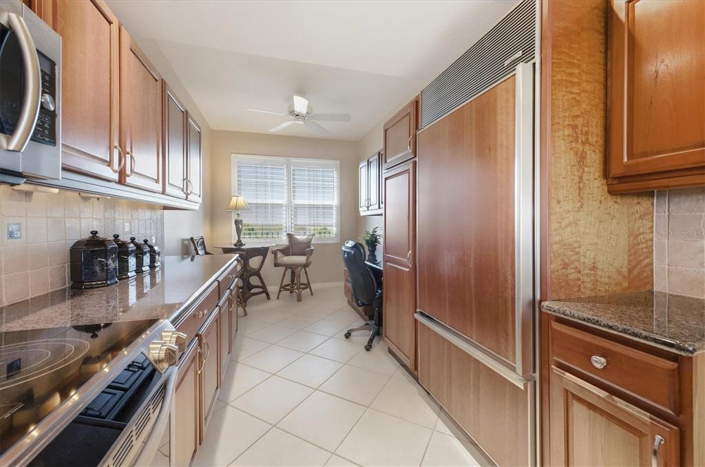 13113 Gasparilla Road, Unit 403 Placida, FL 33946 - Photo 12 of 53 a kitchen with counter top space a sink a refrigerator and cabinets