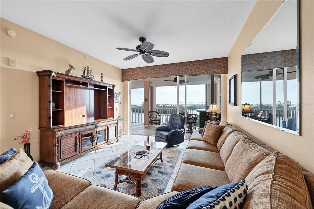 13113 Gasparilla Road, Unit 403 Placida, FL 33946 - Photo 6 of 53 a living room with furniture ceiling fan and a flat screen tv