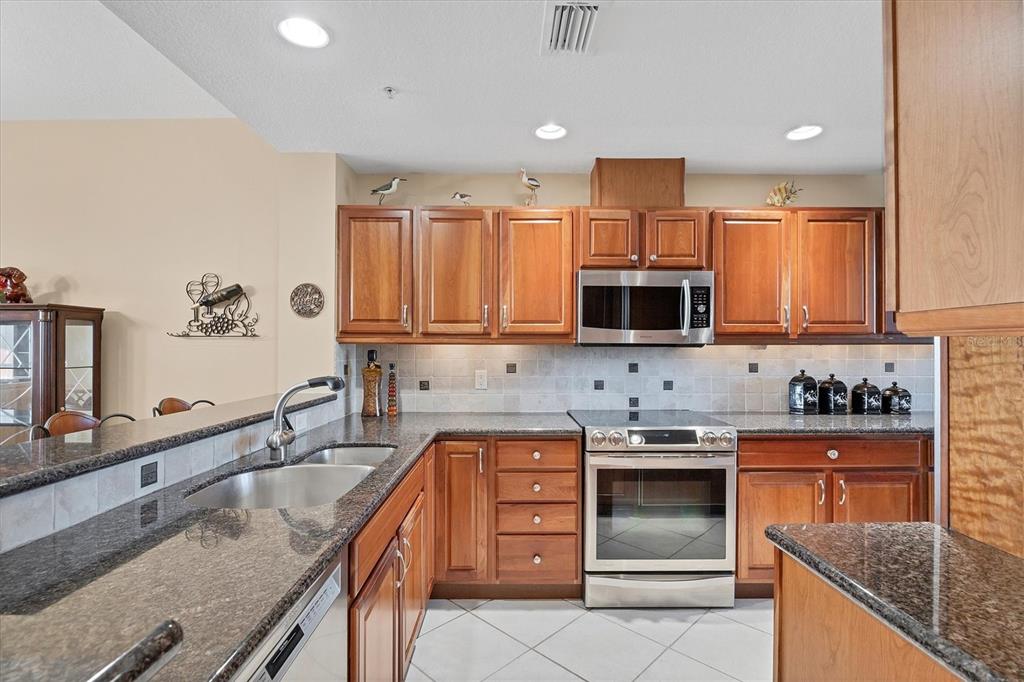 13113 Gasparilla Road, Unit 403 Placida, FL 33946 - Photo 9 of 53 a kitchen with stainless steel appliances granite countertop a sink stove and oven