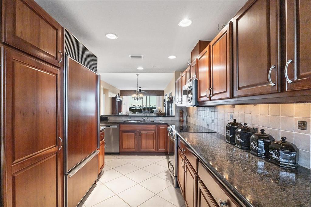 13113 Gasparilla Road, Unit 403 Placida, FL 33946 - Photo 10 of 53 a kitchen with stainless steel appliances granite countertop a refrigerator and a sink