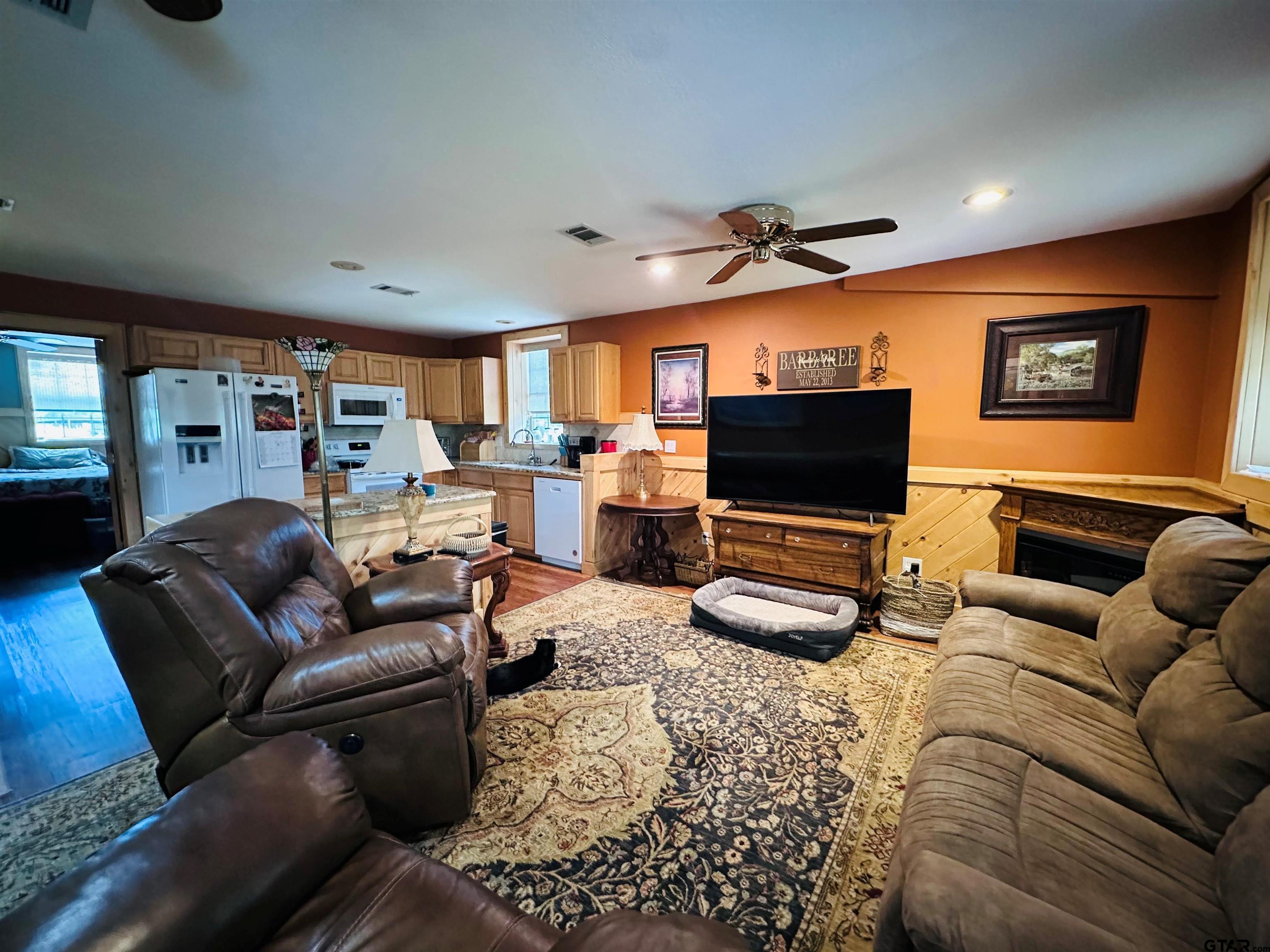 6454 Clear Creek Road Mabank, TX 75156 - Photo 4 of 17 a living room with furniture and a flat screen tv