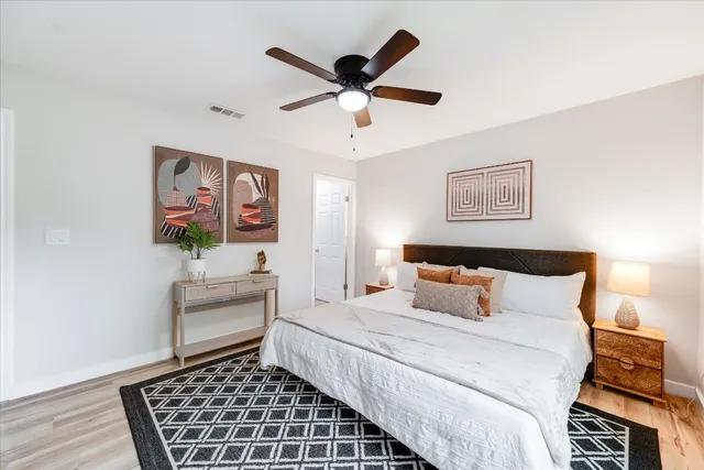 a bedroom with a bed and a ceiling fan