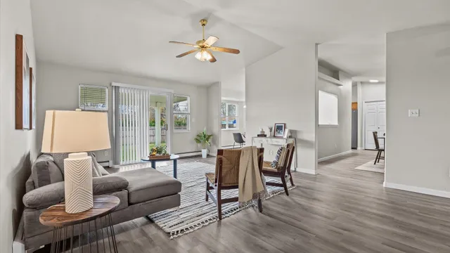 a living room with furniture and a wooden floor