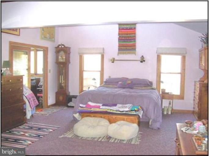 1704 Dahlgren Road Middletown, MD 21769 - Photo 9 of 17 a bedroom with a bed and wooden floor