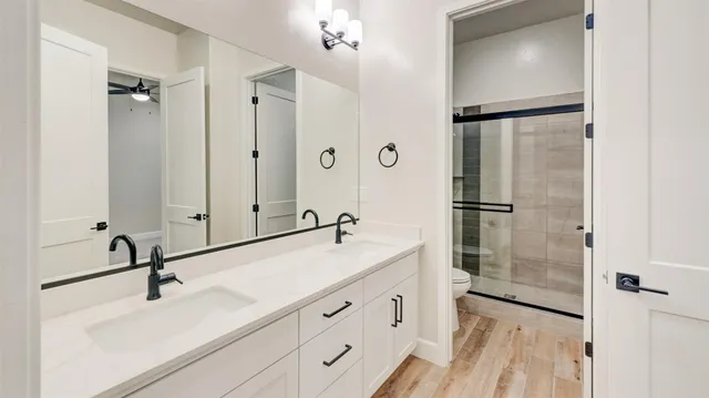 a bathroom with a sink mirror and shower