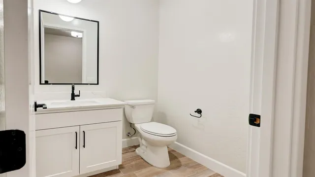 a bathroom with a toilet sink and mirror