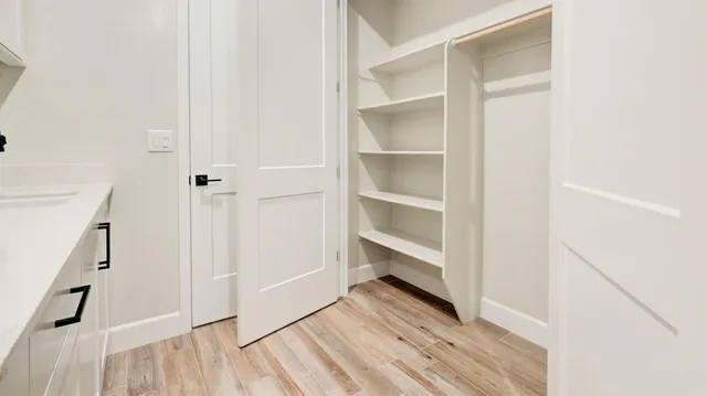 a view of walk in closet with empty racks