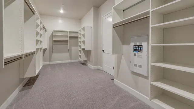 a view of walk in closet with empty racks
