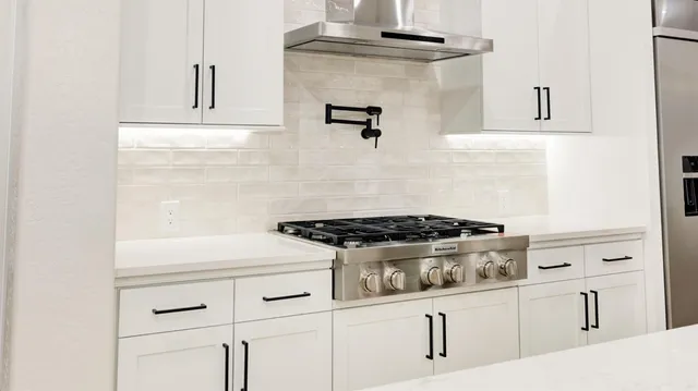 a stove top oven sitting inside of a kitchen