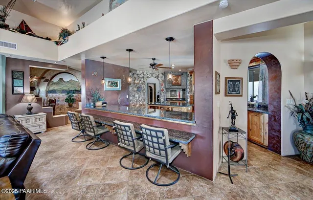 a view of a livingroom with furniture mirror and hardwood floor