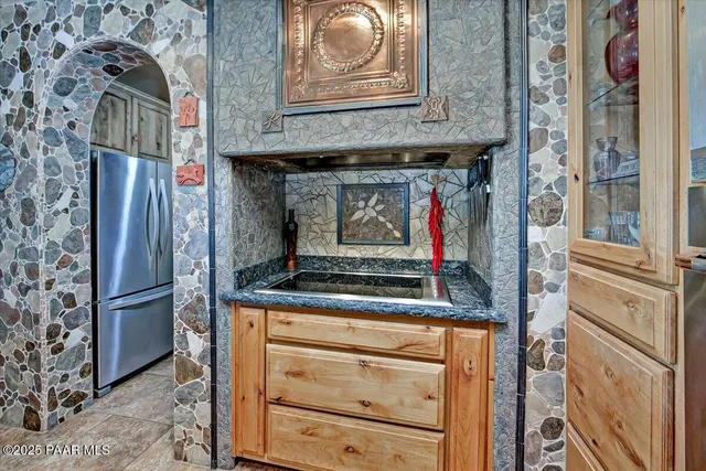 a spacious bedroom with a bed couch and window