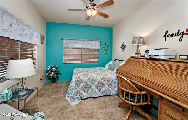 a bedroom with furniture and a floor to ceiling window