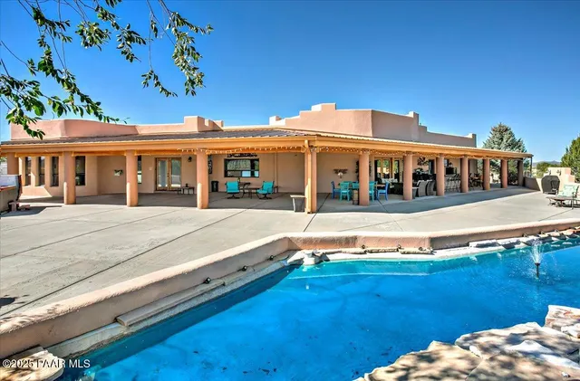a view of a city with lush green forest in the back