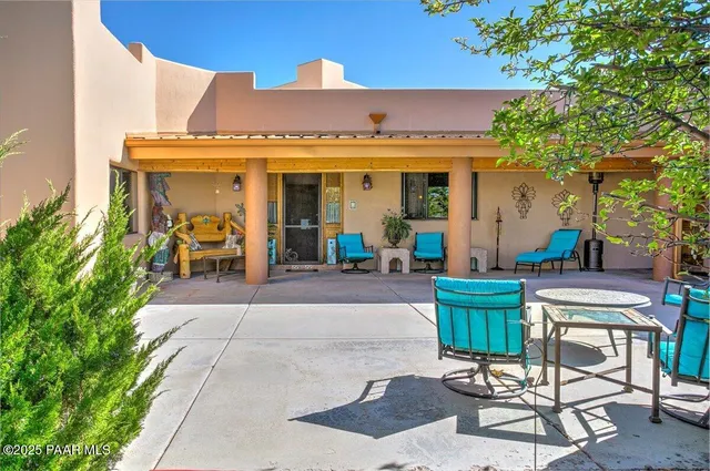 a kitchen with stainless steel appliances granite countertop a refrigerator and a potted plant