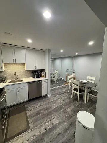 a kitchen with a dining table chairs sink and stove