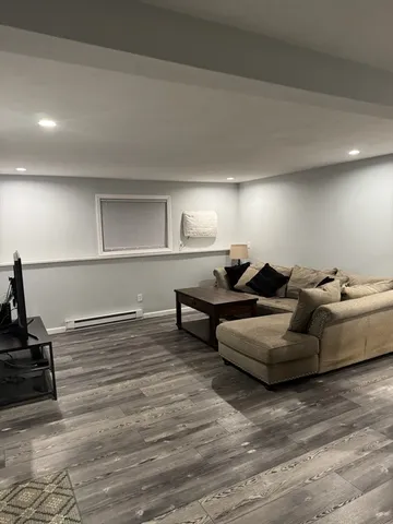 a living room with furniture and a wooden floor